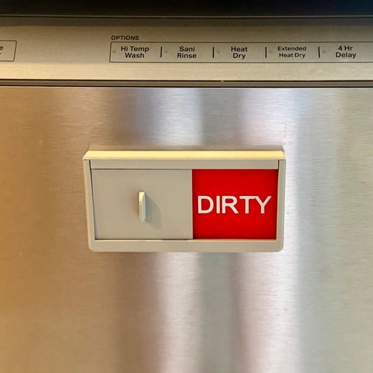 Magnetic dishwasher sign showing red Dirty indicator on dishwasher front panel