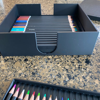 A black colored pencil storage caddy open on a surface displaying multiple colored pencils inside 3
