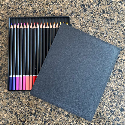 A single black colored pencil storage caddy open on a surface displaying multiple colored pencils inside,