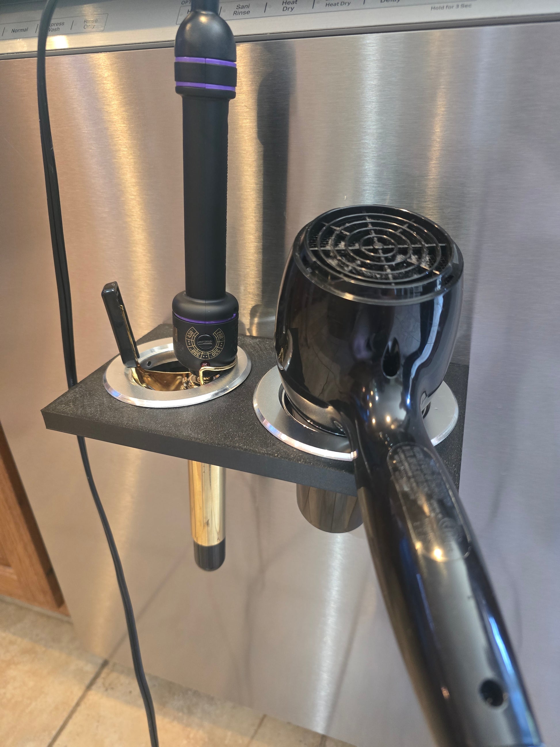 Close up of magnetic mount bracket on hair dryer and curling iron holder