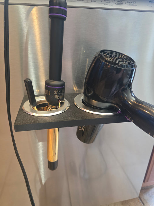 Black hair dryer and curling iron holder mounted on metal surface, magnetic mount